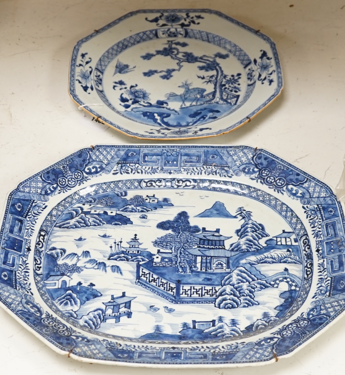 Two 18th century Chinese blue and white dishes, largest 44.5cm long. Condition - fair